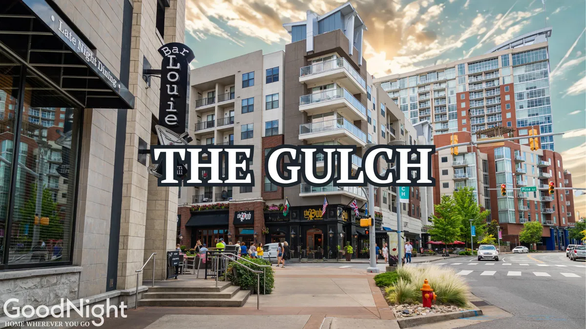 The lively Gulch district is depicted with visible Bar Louie and The Gulch signage, modern apartment buildings, and bustling pedestrian activity. The streetscape feels vibrant and welcoming for business professionals seeking dining or networking after work.
